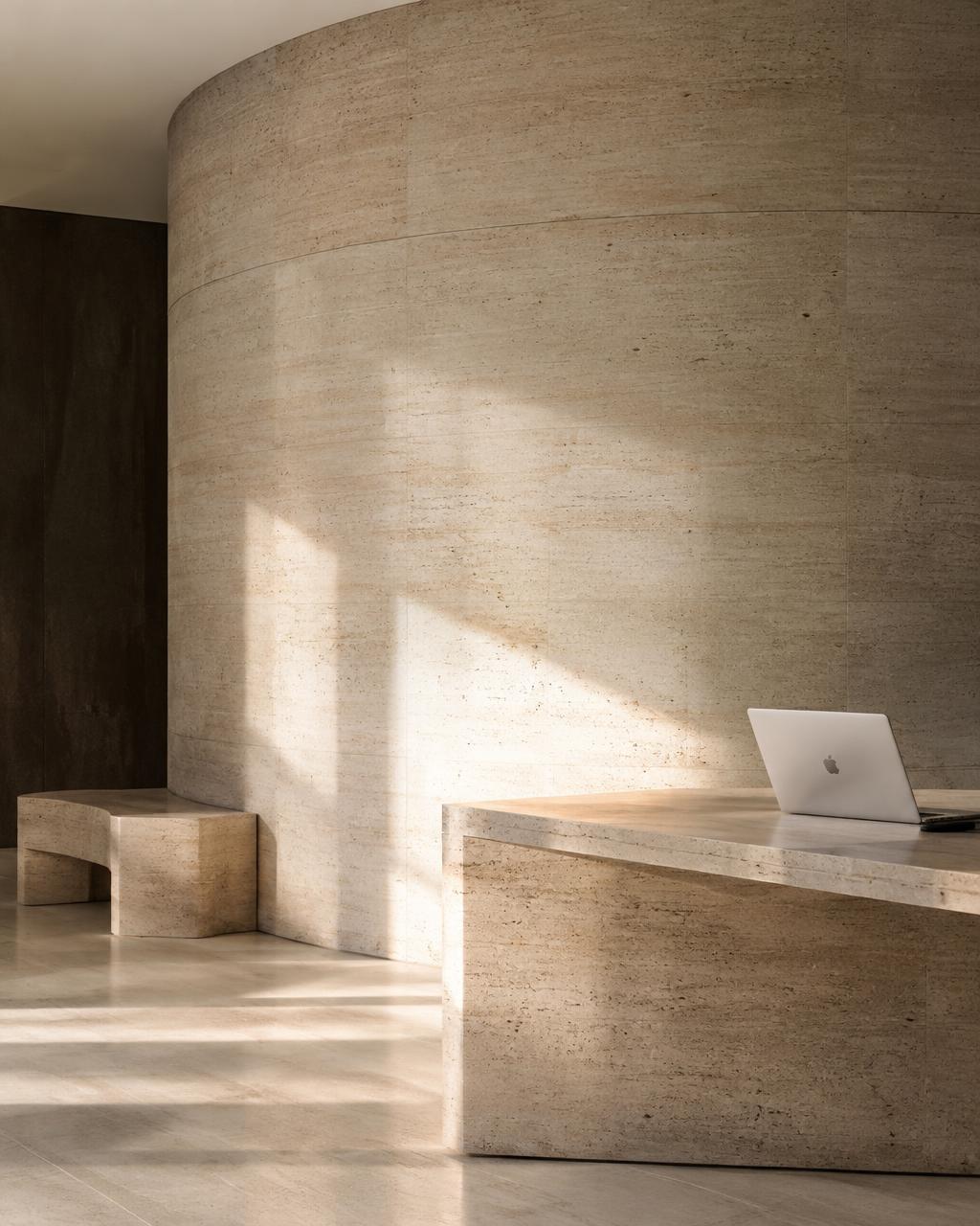 Travertine interior with a laptop on a stone desk